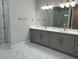 Elegant bathroom with double vanity, modern fixtures, and marble tile flooring at 2510 Lakefront Dr, Lake Wales, FL 33898