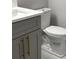Bathroom featuring gray vanity with gold accents, white toilet and tiled flooring at 2510 Lakefront Dr, Lake Wales, FL 33898