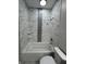 Bathroom featuring a tiled tub and shower with unique accent tile at 2510 Lakefront Dr, Lake Wales, FL 33898
