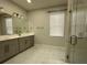 Modern bathroom with double sinks, a walk-in shower, and elegant finishes at 2510 Lakefront Dr, Lake Wales, FL 33898