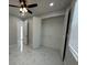 Bedroom with marble floors, ceiling fan, and closet at 2510 Lakefront Dr, Lake Wales, FL 33898