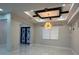 Bright living room with decorative ceiling, modern light fixture and a view of the entry at 2510 Lakefront Dr, Lake Wales, FL 33898