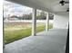 Covered patio with ceiling fans, columns and a view of the spacious backyard at 2510 Lakefront Dr, Lake Wales, FL 33898