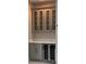Elegant wet bar with upper glass cabinets, counter space, and under-counter cooler at 2510 Lakefront Dr, Lake Wales, FL 33898