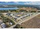 Aerial view of a residential community near a lake and farmlands at 264 Spirit Landings Cir, Winter Haven, FL 33880