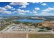 A community view of single-Gathering homes nestled near a serene lake and lush green spaces at 264 Spirit Landings Cir, Winter Haven, FL 33880