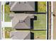 Overhead view of a modern home with a grassy backyard, set between neighboring properties and landscaping at 264 Spirit Landings Cir, Winter Haven, FL 33880