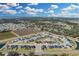 Aerial view of a residential community near farmlands and a lake at 264 Spirit Landings Cir, Winter Haven, FL 33880