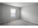 Neutral bedroom with carpet flooring, a window, and electrical outlets at 264 Spirit Landings Cir, Winter Haven, FL 33880