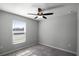 Neutral bedroom featuring a ceiling fan, carpeted floor, and a window at 264 Spirit Landings Cir, Winter Haven, FL 33880