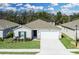 Beautiful single-story home with a manicured front lawn and a paved driveway leading to a two-car garage at 264 Spirit Landings Cir, Winter Haven, FL 33880