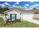 Charming single-Gathering home with a well-manicured lawn, complemented by a two-car garage at 264 Spirit Landings Cir, Winter Haven, FL 33880