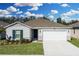Single-story home with two-car garage and landscaping at 264 Spirit Landings Cir, Winter Haven, FL 33880