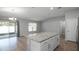 Kitchen island with sleek granite countertops and ample storage space, plus access to the patio at 264 Spirit Landings Cir, Winter Haven, FL 33880