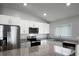 Bright kitchen features granite countertops, stainless steel appliances, and white cabinetry at 264 Spirit Landings Cir, Winter Haven, FL 33880