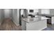 Modern kitchen features stainless steel appliances, granite countertops, and an island for added convenience at 264 Spirit Landings Cir, Winter Haven, FL 33880