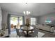 Cozy living space with patio access, neutral decor, and sleek entertainment setup for comfortable living at 264 Spirit Landings Cir, Winter Haven, FL 33880