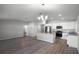 Open-concept living and dining area features modern kitchen with stainless steel appliances and plenty of space at 264 Spirit Landings Cir, Winter Haven, FL 33880