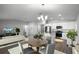 Open-concept living and dining area features stylish decor and a modern kitchen with stainless steel appliances at 264 Spirit Landings Cir, Winter Haven, FL 33880