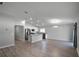 Bright open-concept living area with modern kitchen featuring stainless steel appliances and granite countertops at 264 Spirit Landings Cir, Winter Haven, FL 33880