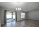 Bright living room boasts hardwood floors, large glass sliding doors, and modern lighting at 264 Spirit Landings Cir, Winter Haven, FL 33880