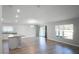 Bright open-concept living space with sliding glass door to patio, and modern kitchen with island seating at 264 Spirit Landings Cir, Winter Haven, FL 33880