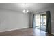 Bright living room boasts hardwood floors, large glass sliding doors, and modern lighting at 264 Spirit Landings Cir, Winter Haven, FL 33880