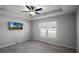 A cozy carpeted bedroom featuring a ceiling fan, and a bright window at 264 Spirit Landings Cir, Winter Haven, FL 33880