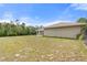 A view of the spacious backyard featuring lush green grass, offering privacy and room to unwind at 2772 Indian Pipes Trl, Frostproof, FL 33843