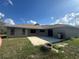 Open backyard featuring a concrete patio, stainless steel grill, and a fire pit for outdoor enjoyment at 2772 Indian Pipes Trl, Frostproof, FL 33843