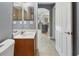 Cozy bathroom with tile floors, wooden vanity, and a private commode at 2772 Indian Pipes Trl, Frostproof, FL 33843