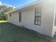 Tan colored home with multiple dark framed windows and ample light at 2772 Indian Pipes Trl, Frostproof, FL 33843