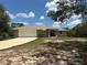 Charming single-story home featuring a two-car garage, neutral paint, and a well-manicured lawn at 2772 Indian Pipes Trl, Frostproof, FL 33843