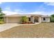 Charming single-story home with a two-car garage and a well-maintained, drought-resistant landscaped front yard at 2772 Indian Pipes Trl, Frostproof, FL 33843