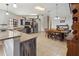 Bright, open kitchen with granite countertops, ample cabinet space, stainless steel appliances, and dining area at 2772 Indian Pipes Trl, Frostproof, FL 33843