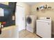 Functional laundry room featuring a side-by-side washer and dryer, and storage shelves at 2772 Indian Pipes Trl, Frostproof, FL 33843