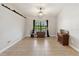 Well-lit living space, featuring neutral wall colors and a large window showcasing the outdoor views at 2772 Indian Pipes Trl, Frostproof, FL 33843