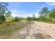 Overview of a spacious vacant lot with a dirt road and scattered vegetation at 2772 Indian Pipes Trl, Frostproof, FL 33843