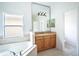 Bathroom with soaking tub and wood vanity at 3526 Valleyview Dr, Kissimmee, FL 34746