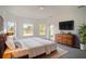 Main bedroom with a large bed and access to backyard at 3526 Valleyview Dr, Kissimmee, FL 34746