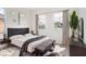 Bright bedroom with a dark-grey upholstered bed and bench at 3526 Valleyview Dr, Kissimmee, FL 34746
