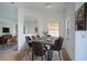Bright dining room with a large table and six brown leather chairs at 3526 Valleyview Dr, Kissimmee, FL 34746