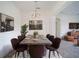 Elegant dining room with a long concrete table and six brown velvet chairs at 3526 Valleyview Dr, Kissimmee, FL 34746
