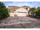 Two-story house with three-car garage, paver driveway, and landscaping at 3526 Valleyview Dr, Kissimmee, FL 34746
