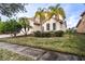 Two-story house with a lush lawn and palm trees at 3526 Valleyview Dr, Kissimmee, FL 34746