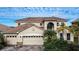Two-story house with tan exterior, tile roof, and a three-car garage at 3526 Valleyview Dr, Kissimmee, FL 34746
