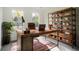 Rustic home office with large wood desk and industrial shelving at 3526 Valleyview Dr, Kissimmee, FL 34746