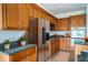 Spacious kitchen with wood cabinets, granite counters, and stainless steel appliances at 3526 Valleyview Dr, Kissimmee, FL 34746