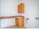 Bright laundry room with wood cabinets and countertop at 3526 Valleyview Dr, Kissimmee, FL 34746