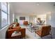 Spacious living room with brown leather sofas and a large window at 3526 Valleyview Dr, Kissimmee, FL 34746